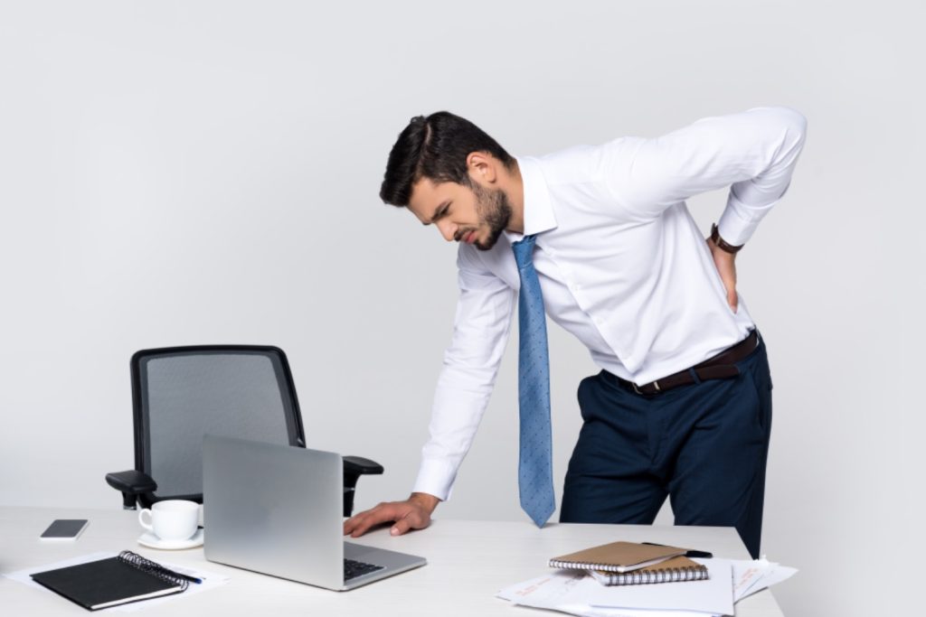 Man in the office with back pain