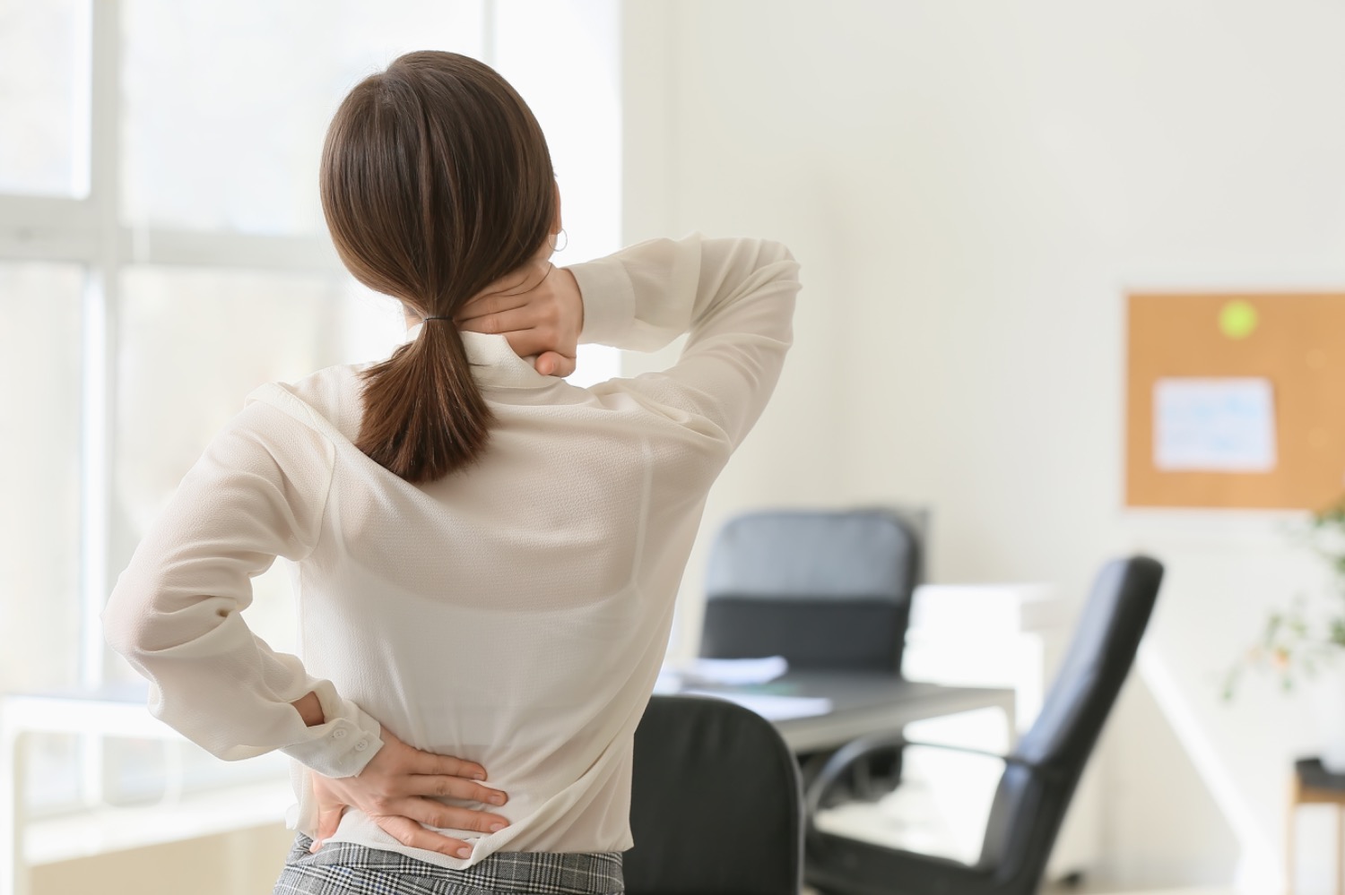 Woman in the office with neck pain